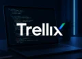 Close-up of a developer laptop displaying clean source code in a dark, minimal workspace with soft blue lighting, representing the Trellix source code leak, with a Trellix logo intended to be overlaid in the center to highlight the breach context.
