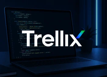 Close-up of a developer laptop displaying clean source code in a dark, minimal workspace with soft blue lighting, representing the Trellix source code leak, with a Trellix logo intended to be overlaid in the center to highlight the breach context.